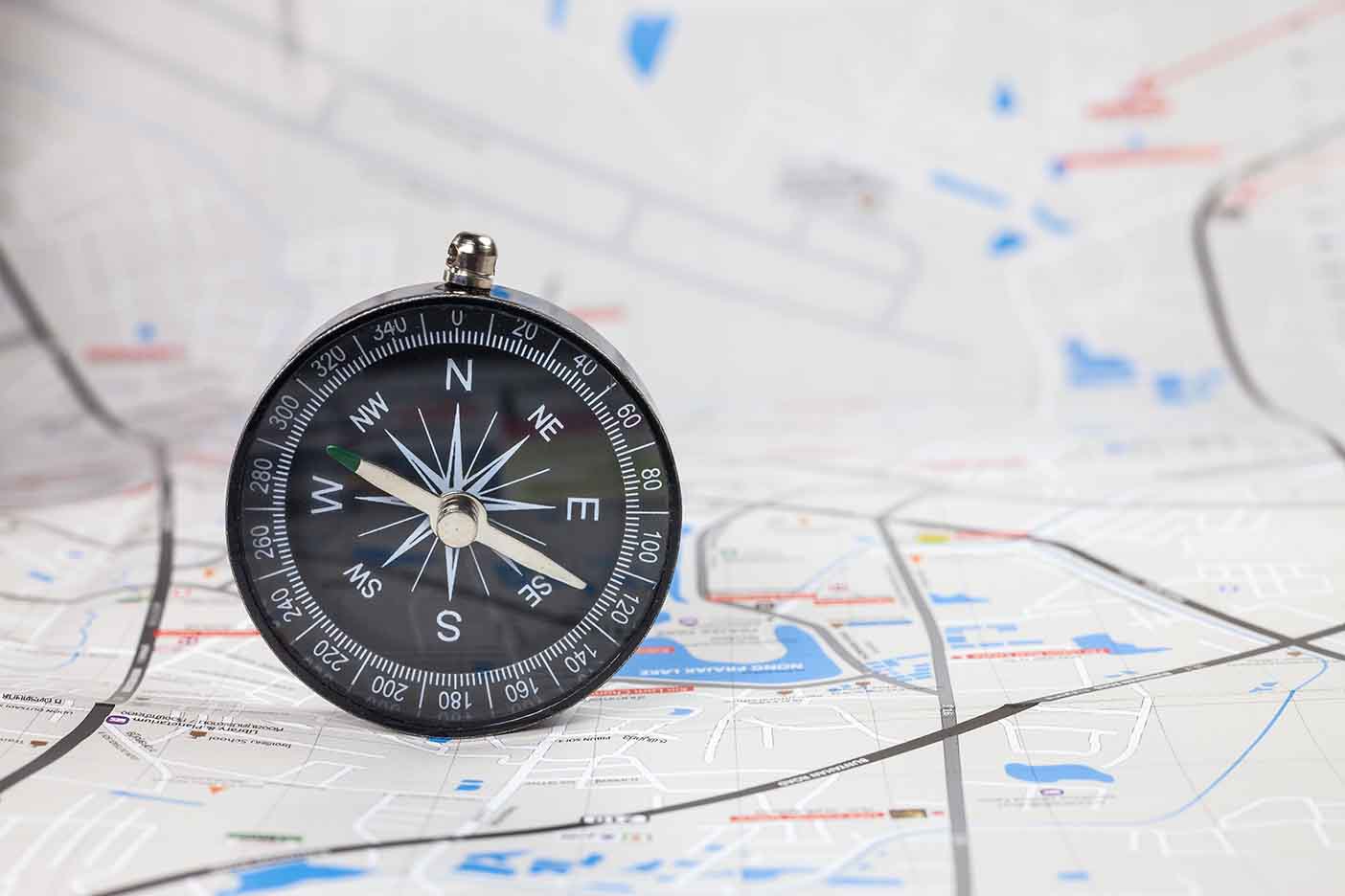 compass sitting upright on map